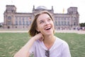 Portrait of a smiling girl in a white T-shirt against the backdrop of architecture in Berlin, Germany Royalty Free Stock Photo