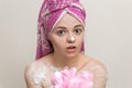 Portrait of smiling girl woman with wet hair wrapped in pink towel taking shower or bath with foam and lather of soap. Royalty Free Stock Photo