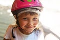 Portrait of a smiling girl 5 years in a pink bicycle helmet close-up on the street Royalty Free Stock Photo