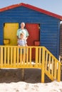 Portrait of smiling grandfather and boy standing at beach hut Royalty Free Stock Photo