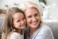 Portrait of smiling grandmother and granddaughter hugging at hom Royalty Free Stock Photo