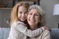 Portrait of smiling grandmother and little granddaughter hugging Royalty Free Stock Photo