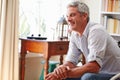 Portrait ofÃ¯Â¿Â½a smiling grey haired man sitting in a room