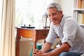 Portrait ofÃ¯Â¿Â½a smiling grey haired man sitting in a room