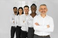 Portrait of a smiling group of diverse corporate colleagues standing in a row together in a bright modern office Royalty Free Stock Photo