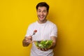 Portrait of Smiling Guy Holding Bowl With Salad Royalty Free Stock Photo