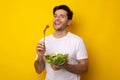 Portrait of Smiling Guy Holding Plate With Salad Royalty Free Stock Photo