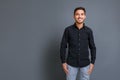 Portrait of smiling handsome and confident young businessman in black shirt Royalty Free Stock Photo