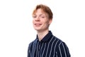 portrait of a smiling handsome european 25s blond man in a blue polo