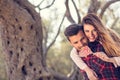 Portrait of smiling handsome man giving piggy back to his girlfriend in the nature Royalty Free Stock Photo