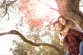 Portrait of smiling handsome man giving piggy back to his girlfriend in the nature Royalty Free Stock Photo