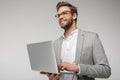 Portrait of smiling handsome man holding and using laptop Royalty Free Stock Photo