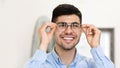 Portrait of smiling handsome man trying on spectacles Royalty Free Stock Photo