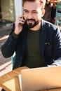 Portrait of a smiling handsome man working on laptop Royalty Free Stock Photo