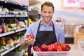 Portrait of a smiling handsome taking a vegetable on his hand