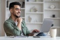 Portrait Of Smiling Handsome Young Arab Man On Laptop At Home Office Royalty Free Stock Photo