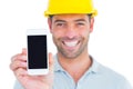 Portrait of smiling handyman showing smart phone