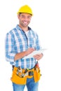 Portrait of smiling handyman writing on clipboard Royalty Free Stock Photo