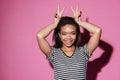 Portrait of a smiling happy african girl showing peace sign Royalty Free Stock Photo