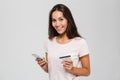 Portrait of a smiling happy asian woman holding credit card