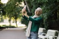 Portrait of smiling happy beautiful muslim woman relaxing using digital smartphone. Royalty Free Stock Photo