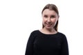 Portrait of a smiling happy Caucasian pre-teen girl wearing a black turtleneck on a white background Royalty Free Stock Photo