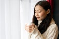 Portrait smiling happy cheerful beautiful pretty asian woman holding drinking and looking at hot coffee Royalty Free Stock Photo