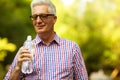 Portrait of a smiling happy mature old man in trendy casual sh Royalty Free Stock Photo