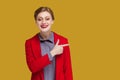 Smiling happy positive woman with red lips pointing finger aside at copy space for advertisement. Royalty Free Stock Photo