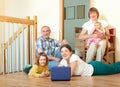 Portrait of smiling happy three generations family with two children and lap top Royalty Free Stock Photo