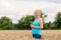 Portrait of a smiling happy woman in a ripe field.