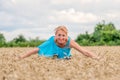 Portrait of a smiling happy woman in a ripe wheat field.