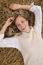 Portrait of smiling happy young woman lying on the grass Royalty Free Stock Photo