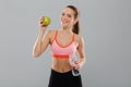 Portrait of smiling healthy sports girl holding green apple Royalty Free Stock Photo