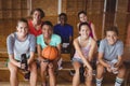 Portrait of smiling high school kids sitting on bench