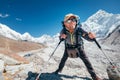 Portrait of smiling Hiker man with Nuptse 7861 m peak and Gorak shep settlement background with trekking poles, UV protecting Royalty Free Stock Photo