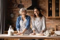 Portrait of smiling Latino mom and daughter baking together Royalty Free Stock Photo