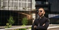 Portrait of smiling Indian Arabic businessman arms crossed wearing sunglasses