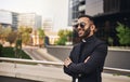 Portrait of smiling Indian Arabic businessman arms crossed wearing sunglasses