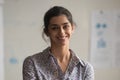 Portrait of smiling indian female employee posing for photo