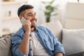 Portrait of smiling jew man talking on phone at home Royalty Free Stock Photo