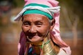 Pan Pet, Kayah State, Myanmar - February 2020: Portrait of an elderly Kayan longneck woman or Paduang wearing pink headdress