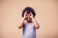 A portrait of smiling kid boy showing binocular gesture. Children and emotions concept Royalty Free Stock Photo