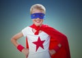 Portrait of smiling kid wearing red cape and blue mask standing with hand on hip against clear sky Royalty Free Stock Photo