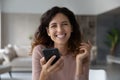 Portrait of smiling Latin woman use smartphone online Royalty Free Stock Photo