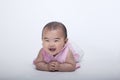 Portrait of smiling and laughing baby lying down, studio shot, white background Royalty Free Stock Photo