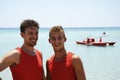 Portrait of smiling lifeguards against beautiful sea on a sunny day. Salento, Apulia, Italy