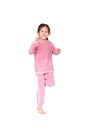 Portrait of smiling little Asian child girl in pink tracksuit or sport cloth running isolated over white background. Freedom and Royalty Free Stock Photo