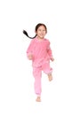 Portrait of smiling little Asian child girl in pink tracksuit or sport cloth running isolated over white background. Freedom and Royalty Free Stock Photo