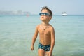 Portrait smiling little baby boy playing in the sea, ocean. Positive human emotions, feelings, joy. Funny cute child making vacati Royalty Free Stock Photo